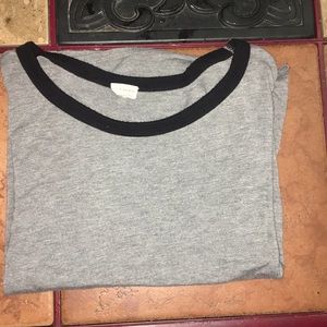 grey shirt with black neckline